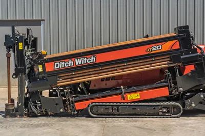 2021 Ditch Witch JT20 side profile, showing drill pipe rack, rubber tracks, engine cowling, and vertical carriage assembly.