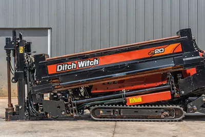 2017 Ditch Witch JT20 HDD rig, side profile, drill frame angled up, drill pipe loaded, rubber tracks, hydraulic components visible