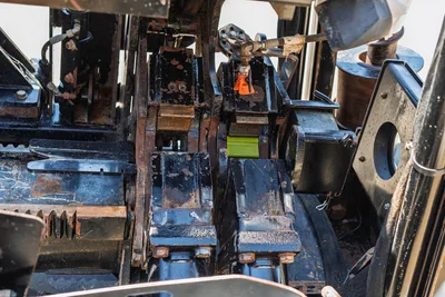 2018 Ditch Witch JT30 All Terrain drill frame close-up showing vise clamps, hydraulic lines, wear from use