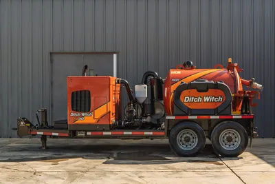 2022 Ditch Witch HX30 mud recycler on tandem-axle trailer, full profile view, orange vacuum tank, engine enclosure, mud pump visible