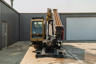 2017 Vermeer D100x140 S3 HDD drill, rear view, enclosed cab, loaded drill pipe rack, exposed carriage and tracks