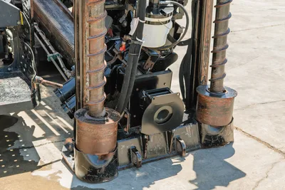 2018 Ditch Witch JT30 All Terrain drill frame close-up showing dual anchor screws, spindle, hydraulic lines, and wear-used components