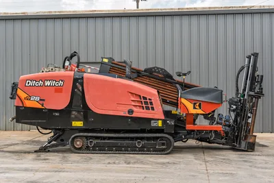 2021 Ditch Witch JT28 HDD drill, full profile view, rubber tracks, loaded drill pipe rack, angled carriage, hydraulic components visible