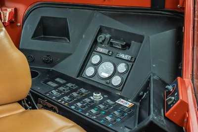 2012 Ditch Witch JT3020 operator station control panel with analog gauges, rocker switches, and tan seat upholstery.