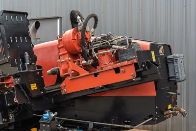 2016 Ditch Witch JT25 drill carriage closeup showing rotary drive, hydraulic manifold, hoses, and thrust frame assembly