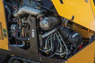2016 Vermeer D23x30 S3 open engine compartment showing diesel engine, exhaust, hydraulic pumps, and hose manifold