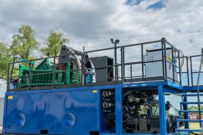 2023 American Augers M300DH mud recycler, blue tank base, green shaker deck, control panel, pump manifold, walkway grating, low-angle view