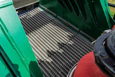 2023 American Augers M300DH shaker screen deck close-up showing corrugated vibrating screen panels with green side panels and brush seals.