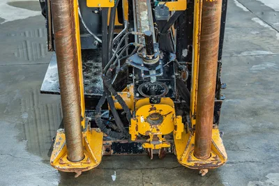 Vermeer D23x30 S3 HDD rig front-end close-up showing vise assembly, hydraulic lines, anchor posts, and worn yellow frame