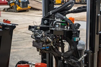 2024 Ditch Witch JT24 drill frame close-up showing hydraulic valve block, beacon lights, wrapped hose bundle, and control wiring