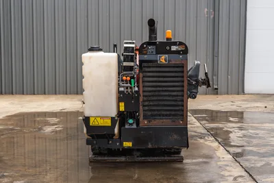 Rear view of 2018 Ditch Witch JT10 HDD rig showing engine compartment, water fluid tank, operator controls, and rubber tracks.