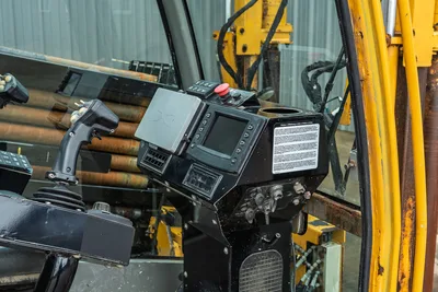 Vermeer 40x55 S3 operator station, interior controls, digital display, and drill pipe rack view from cabin perspective.