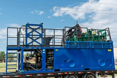 2023 American Augers M300DH mud recycler on trailer, blue skid frame, mixing tank, shaker deck, pump manifold, hydraulic hoses, access ladder visible