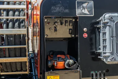 2016 Ditch Witch JT30 All Terrain operator control panel, remote tethered controller storage, and drill pipe rack detail.