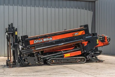 2017 Ditch Witch JT20 HDD rig, angled side view, drill frame elevated, rubber tracks, hydraulic system, drill pipe loaded, anchor system visible