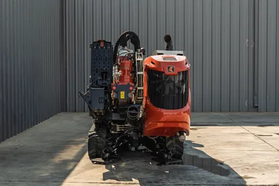 Rear view of 2020 Ditch Witch JT24 HDD drill showing engine housing, rubber tracks, stabilizers, and pipe rack assembly.