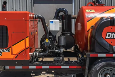 2023 Ditch Witch HX30 mud mixing system, close-up of centrifugal pump, plumbing, air intake, and 500-gal tank on trailer frame