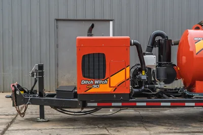 Side profile of 2019 Ditch Witch HX30 vacuum excavator showing engine compartment, intake housing, and 800-gallon spoil tank.
