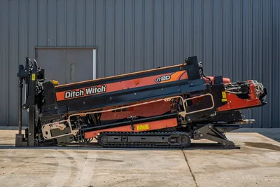 Side profile of 2018 Ditch Witch JT20 HDD drill, showing tracks, pipe loader, drilling carriage, and engine compartment.