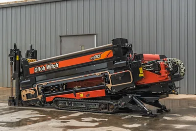 2018 Ditch Witch JT20 HDD drill rig with rubber tracks, pipe rack, engine housing, and hydraulic leveling stabilizers.