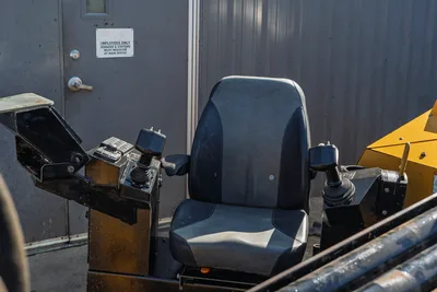 2016 Vermeer D23x30 S3 operator seat with dual joystick controls, armrest consoles, and display panel; drill pipe visible