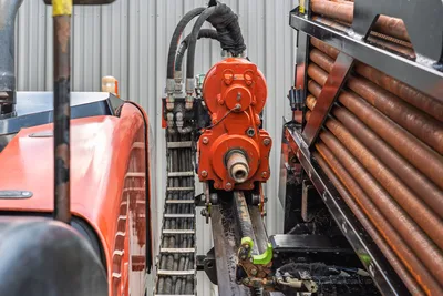 2021 Ditch Witch JT28 spindle/rotary head closeup on drill carriage with loaded pipe rack of 2.375" drill pipe