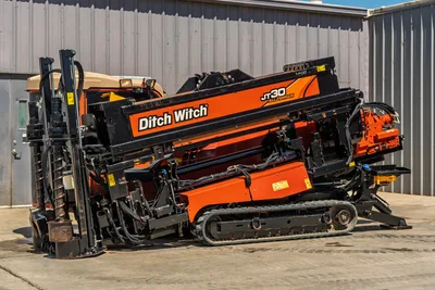 2016 Ditch Witch JT30 All Terrain HDD drill rig showing side profile, track undercarriage, drill pipe, and cabin interior.