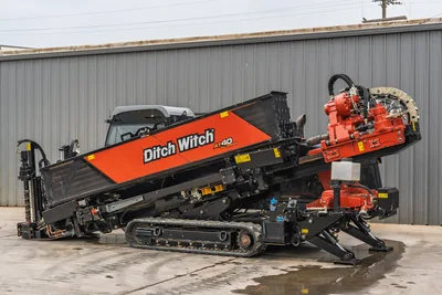 Profile view of 2021 Ditch Witch AT40 All Terrain HDD featuring tracks, enclosed cab, fluid system, and drill pipe rack.