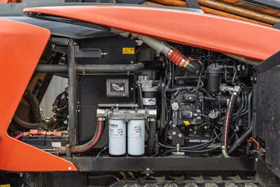 Side view of 2021 Ditch Witch AT40 engine compartment focusing on dual hydraulic oil filters and 165 hp engine assembly.