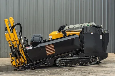 2018 Vermeer D8x12 HDD drill, 3/4 side view, rubber tracks, raised drill stem, operator seat, hydraulic hoses, black engine enclosure
