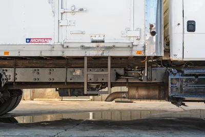 Side profile of 2000 Freightliner FL80 mud truck chassis, Morgan box, frame rails, air horns, and exhaust detail.