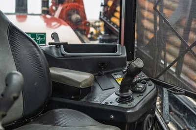 Interior view of 2021 Ditch Witch AT40 operator station, focused on primary joystick controller, seat, and console.