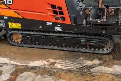 Side profile of 2018 Ditch Witch JT10 HDD showing black rubber tracks, engine compartment vents, and operator station seat.