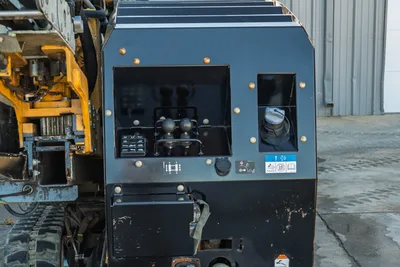 2021 Vermeer D23x30 S3 operator console panel with dual joystick controls, throttle, safety decals, and rubber tracks visible