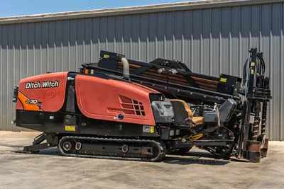 2018 Ditch Witch JT30 All Terrain HDD rig, side view, orange hood, rubber tracks, loaded drill pipe rack, operator controls visible