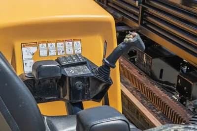 2019 Vermeer D40x55 S3 operator controls: joystick, function keypad, armrest, warning decals, and drill rack with rack-and-pinion gear visible.