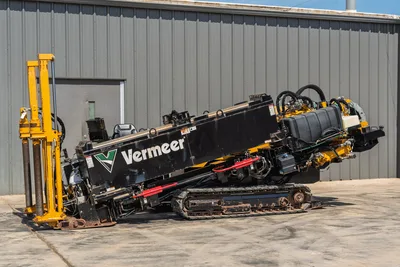 2020 Vermeer D24x40 S3 HDD drill angled up, showing tracks, drill frame, yellow pipe rack, hydraulic hoses, and engine compartment