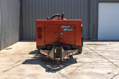 2023 Ditch Witch HX30 mud mixer, front view, trailer hitch with safety chains, orange enclosure, exhaust stack, vented side panel