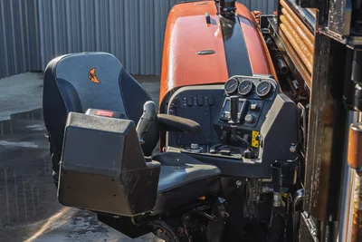 2023 Ditch Witch JT20 operator station featuring control console, adjustable seat, and drill pipe rack in a clean condition.