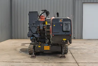 Rear view of 2021 Ditch Witch JT25 HDD drill featuring engine compartment, hydraulic hoses, drill rack, and steel tracks.
