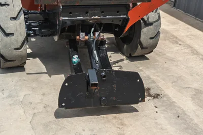 Rear view of Ditch Witch RT80 showing hydraulic plow attachment, lift cylinder, and tire tread condition.