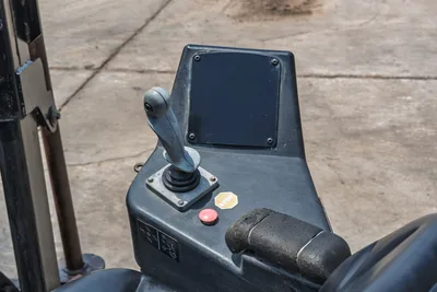 2017 Ditch Witch JT20 operator console, joystick control, display panel, red e-stop button, and worn armrest, close-up overhead angle