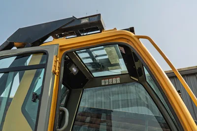 2017 Vermeer D100x140 S3 enclosed cab close-up, yellow ROPS frame, glass roof panel, safety decals, open door view