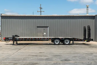Behnke FB8X30SDPT-40L flatbed trailer, full side profile, black steel deck, tandem axle, fold-down ramps, marker lights, pipe stakes