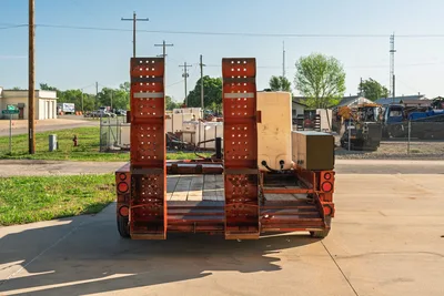 Rear view 2016 Belshe WB14-2EP trailer with ramps up, yellow Ditch Witch FM5x mixing tank.
