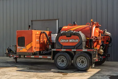 2022 Ditch Witch HX30 mud recycler on tandem-axle trailer; orange vacuum tank, mud pump unit, debris tank, rear plumbing visible