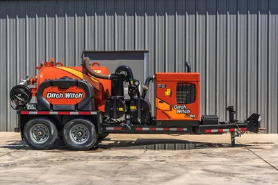 2023 Ditch Witch HX30 mud recycler, full driver-side profile on tandem-axle trailer, orange mixing tank, pump assembly, engine compartment visible