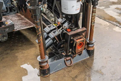 2018 Ditch Witch JT10 drill head, vise assembly, and stabilizer legs, showing hydraulic components and steel track chassis.
