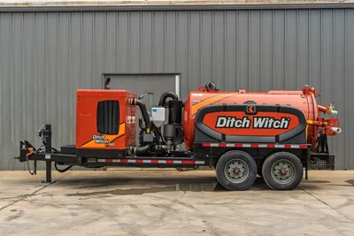 2023 Ditch Witch HX50 mud recycler, full side profile, tandem-axle trailer, orange vacuum tank, engine enclosure, visible plumbing