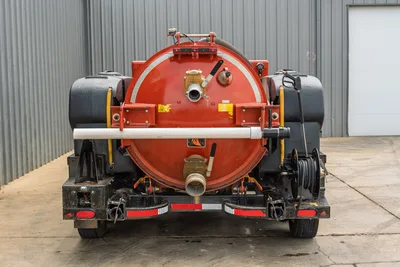 2023 Ditch Witch HX50 mud recycler, rear view showing red spoils tank, brass fittings, side water tanks, hose reel